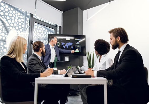 Business meeting with team members discussing analytics and charts